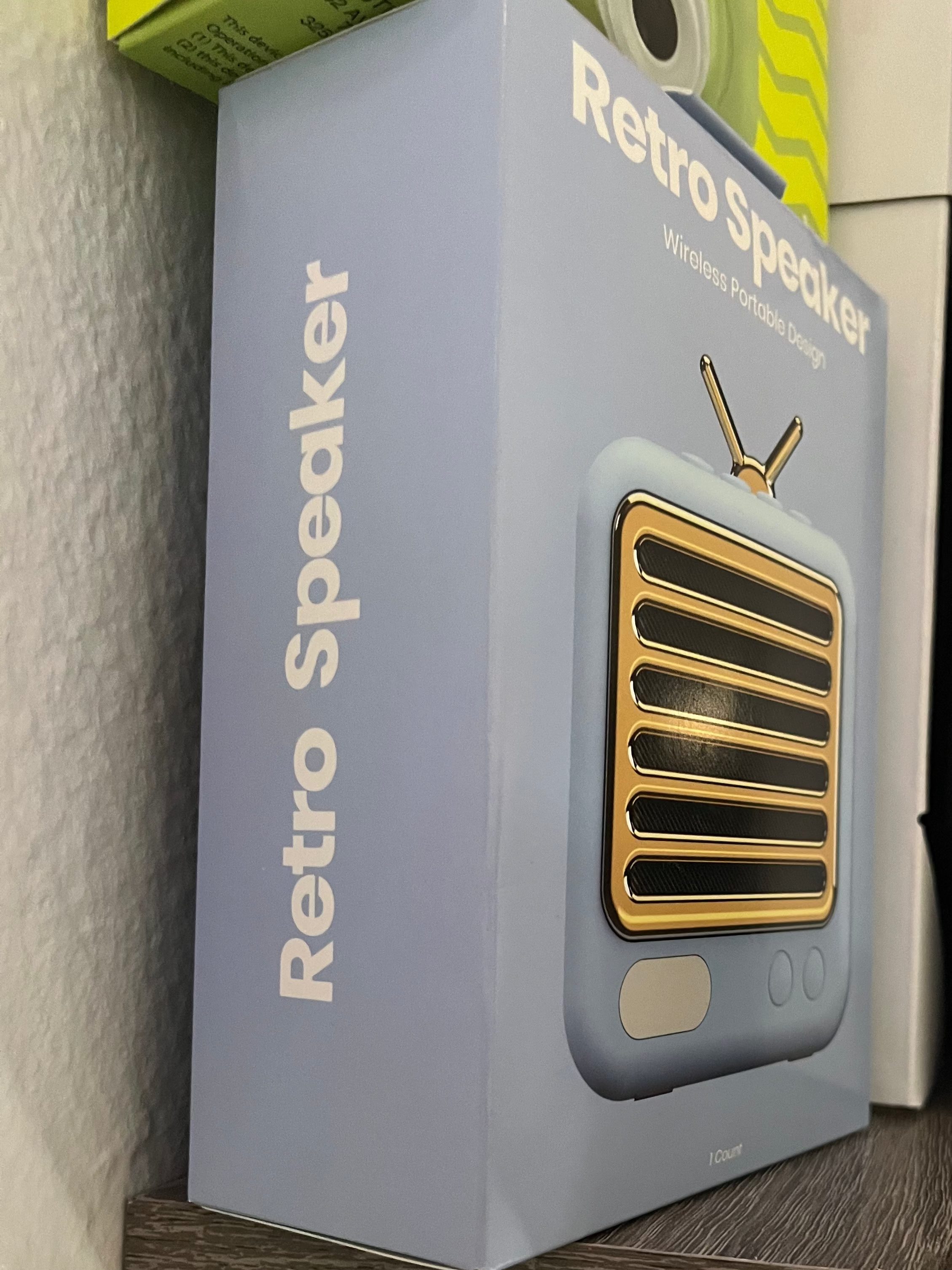 Retro speaker packaging on a shelf with a neutral background